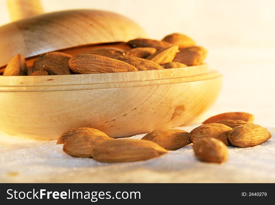 A heap of almonds in wooden container