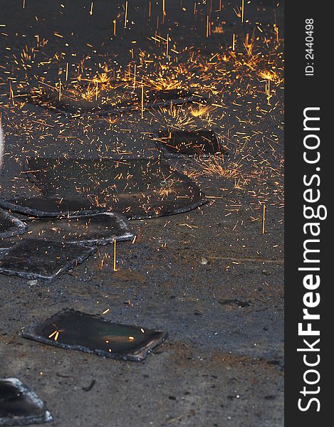 Scrap steel and falling fire from torch. Scrap steel and falling fire from torch