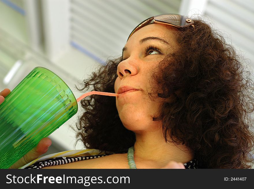 Low angle shot of a culry-haired lemonade destroyer. Low angle shot of a culry-haired lemonade destroyer