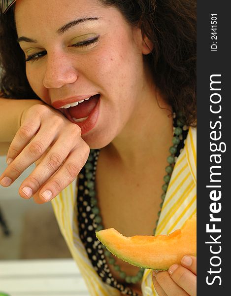 Cute girl drooling over a delicious melon. Cute girl drooling over a delicious melon