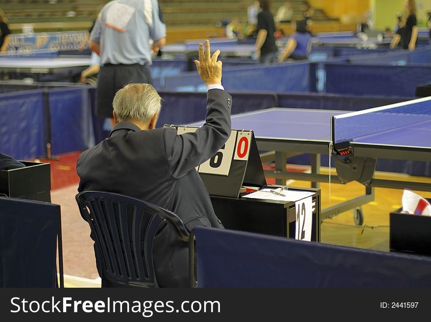 Table tennis referee during a ping-pong competition.