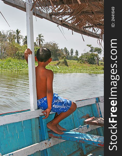 Boy in boat on lagoon, Acapulco, Mexico. Boy in boat on lagoon, Acapulco, Mexico