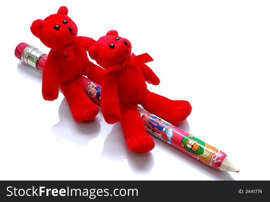 Two red dolls with pencil on the white background. Two red dolls with pencil on the white background