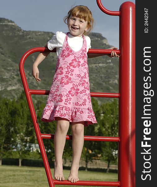 Girl at park climbing on playground equipment. Girl at park climbing on playground equipment