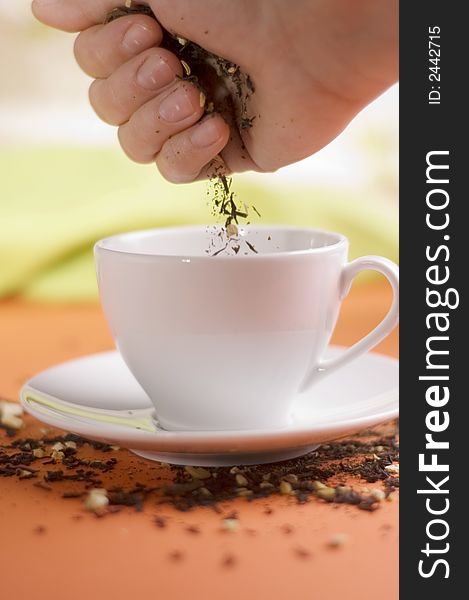 Tea and white cup on the orange background. Tea and white cup on the orange background