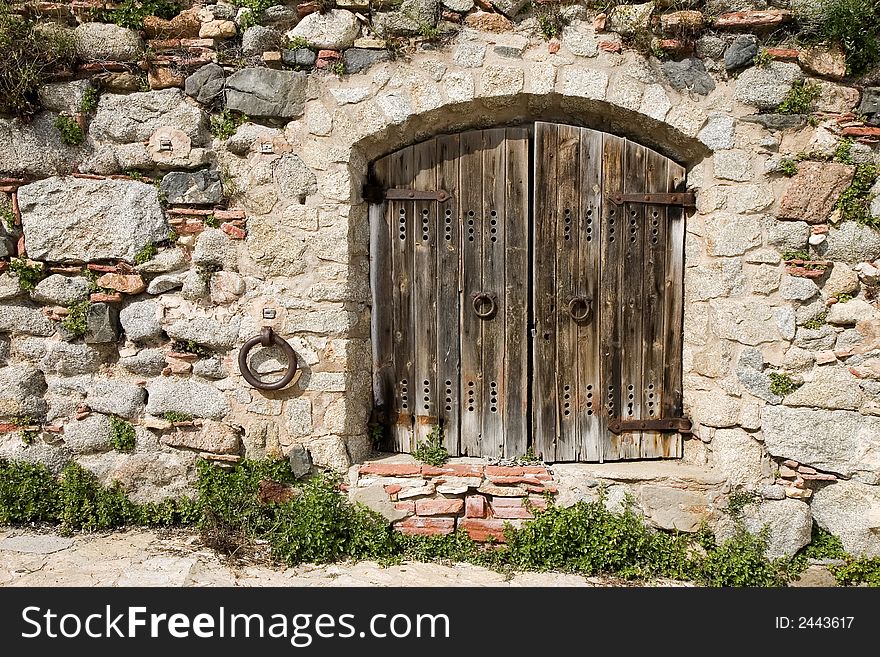 Ancient wooden door in a stone wall. Ancient wooden door in a stone wall