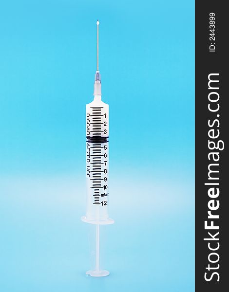 12 ml/cc syringe with chemical on a blue background