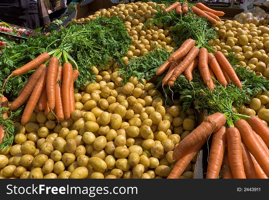 Fresh Carrots and Potatoes on a market stall