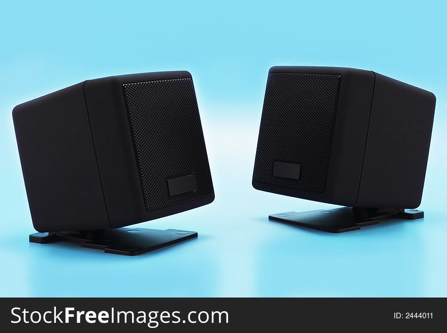 Loudspeakers on a blue background with smooth shadows