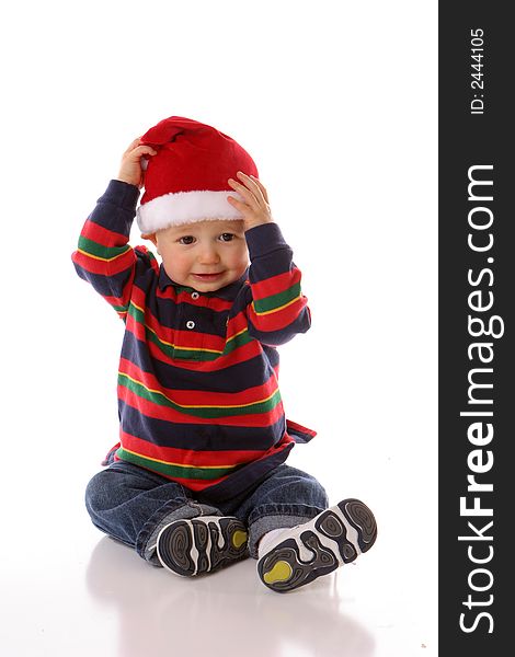 Baby holding his santa hat. Baby holding his santa hat