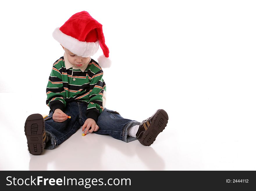 Little boy looking down in santa hat. Little boy looking down in santa hat