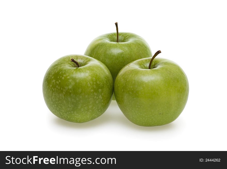 Three tasty green apples isolated on white background.