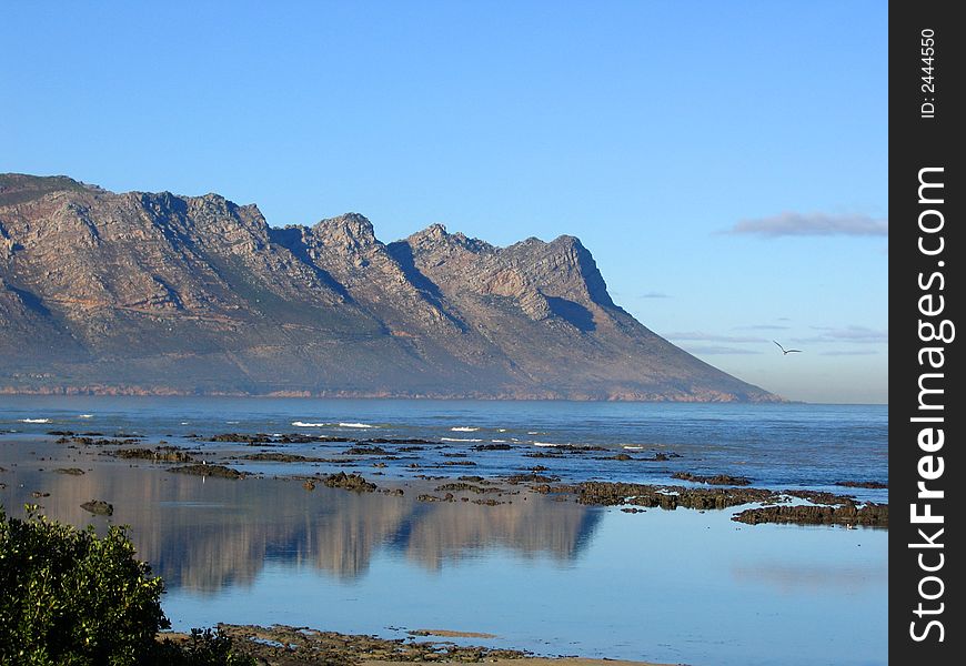 A Reflection of the mountain in the sea at Gordons bay, South Africa. A Reflection of the mountain in the sea at Gordons bay, South Africa.