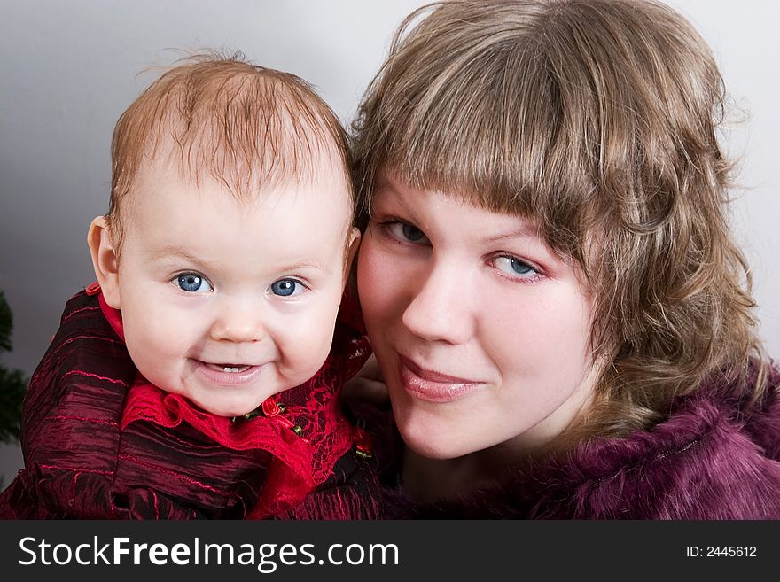 Loving mother with her little cute daughter looking into camera. Loving mother with her little cute daughter looking into camera