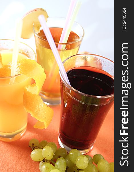 Glass of apple juice, orange juice and grape juice. Glass of apple juice, orange juice and grape juice