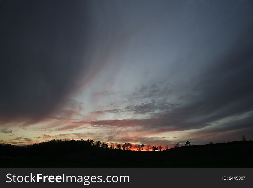 Clouds and sunset over hills with sweeping wind. Clouds and sunset over hills with sweeping wind