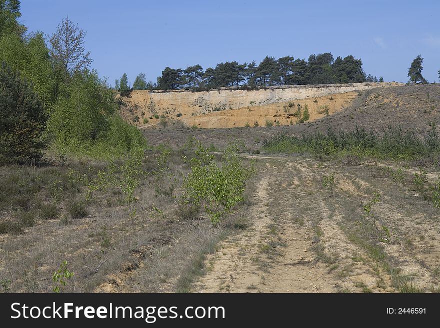 Rough road through a nature landscape with far horizon. Rough road through a nature landscape with far horizon