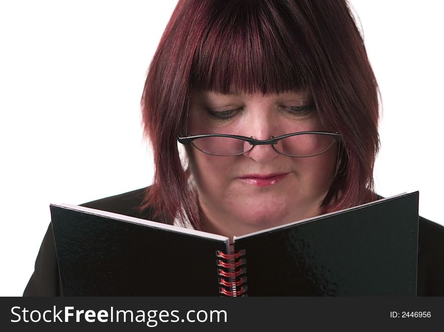 Business woman, looking down, reading notebook. Business woman, looking down, reading notebook