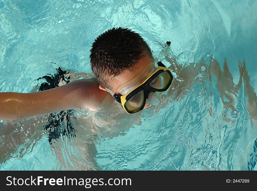 Nine year old boy swimming a freestyle dash. Nine year old boy swimming a freestyle dash