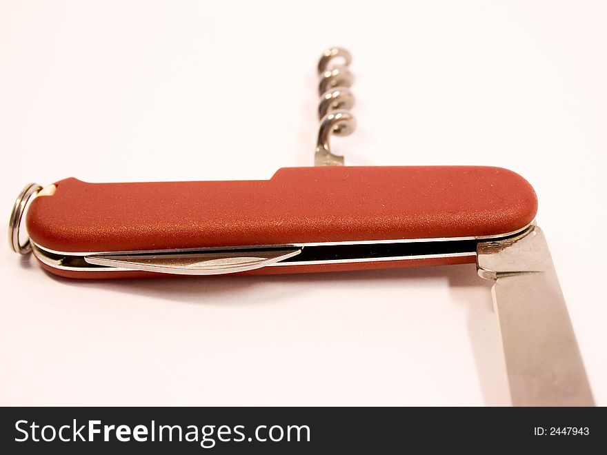 Red pen-knife with steel edge over wgite background