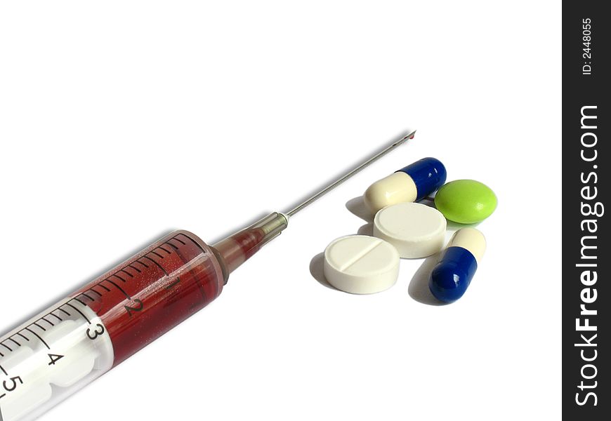 Medicines and a syringe on a white background