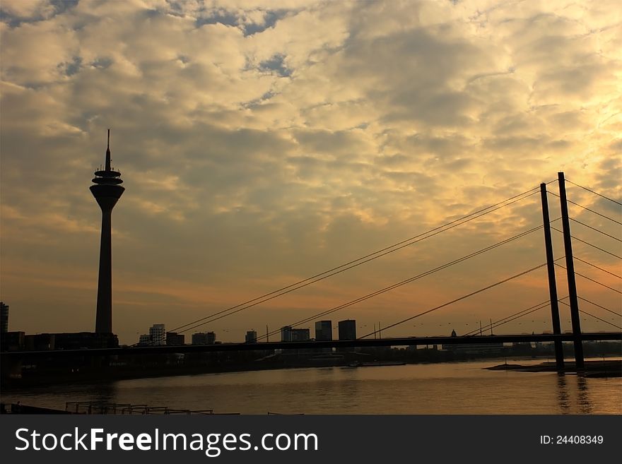 Dusseldorf skyline on the river Rhine, with the silhouette of the TV Tower, and Media Harbor in the back. HDR image. Dusseldorf skyline on the river Rhine, with the silhouette of the TV Tower, and Media Harbor in the back. HDR image