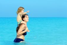 Happy Child With Her Mother On The Beach Royalty Free Stock Photo