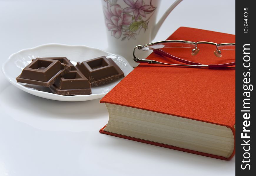 Time to relax-cup of coffee,chocolate,book and glasses. Time to relax-cup of coffee,chocolate,book and glasses