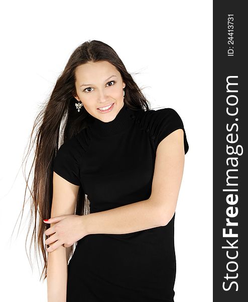 Beautiful brunette girl wearing black dress smiles in white studio