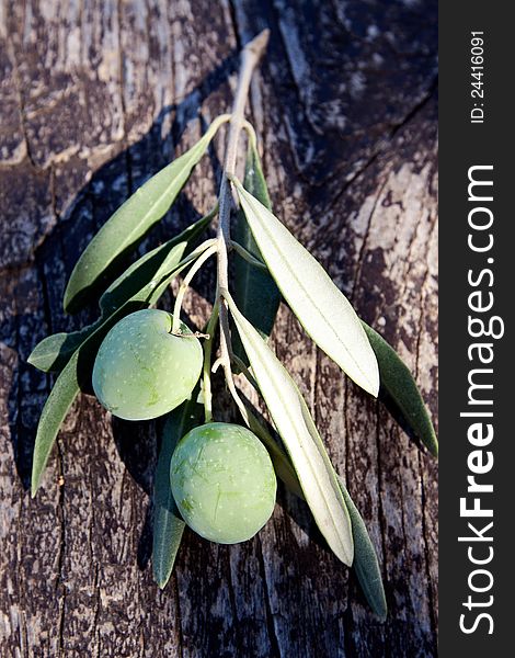 Green olives on a wooden board