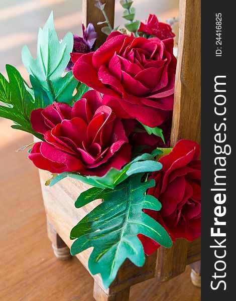 Artificial rose flowers bouquet in wood vase. Artificial rose flowers bouquet in wood vase