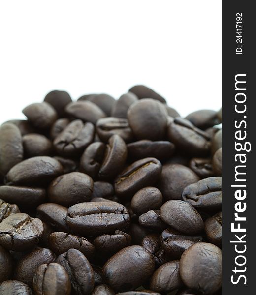 Pile of coffee beans on white background