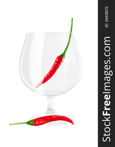 Red peppers in a wine glass on a white background