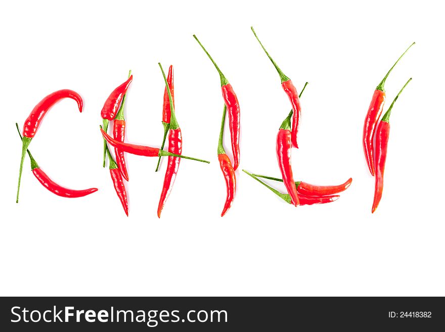 Red peppers in a word CHILI on a white background