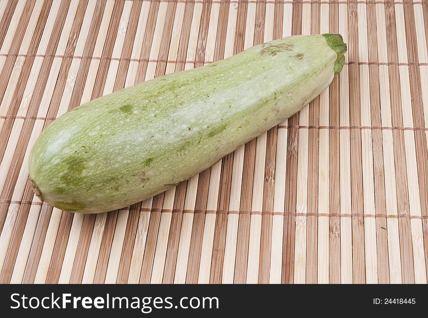 A zucchini on bamboo background