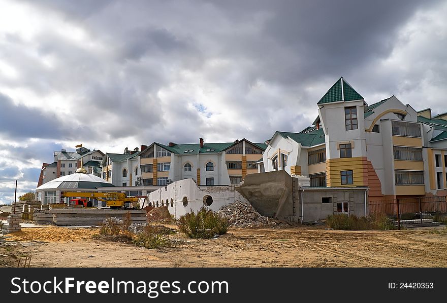 Construction of townhouse in summer landscape under cloud