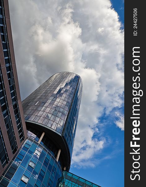 Office tower in a low angle view with attractive clouds at the sky. Office tower in a low angle view with attractive clouds at the sky