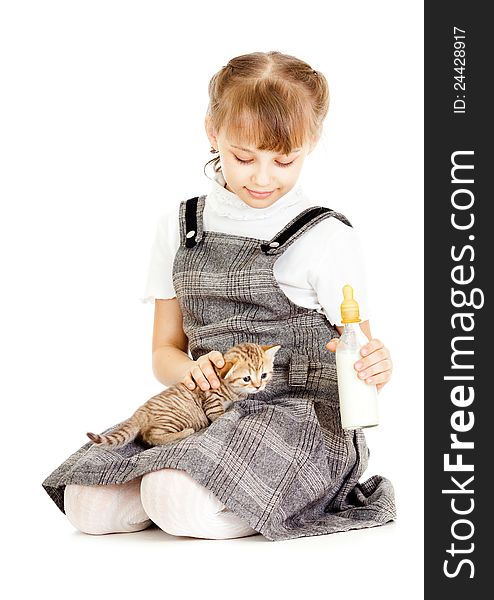 Girl feeding British kitten