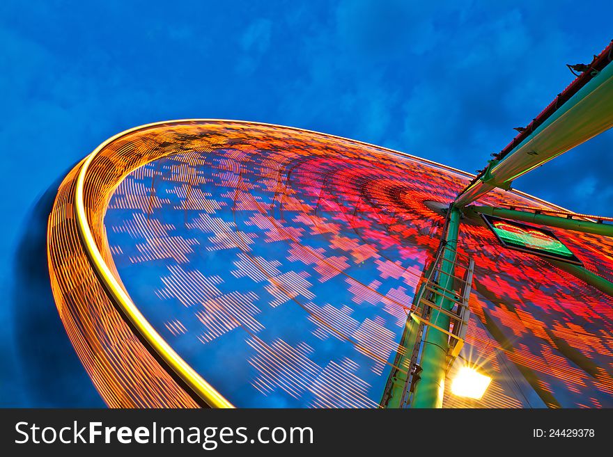 Ferris wheel in motion blur at blue night sky. Ferris wheel in motion blur at blue night sky