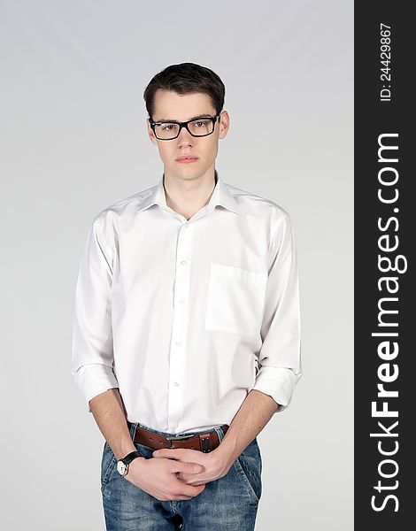 Young man wearing glasses on white background
