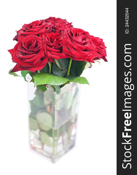 A vase with a bouquet of red roses. A vase with a bouquet of red roses