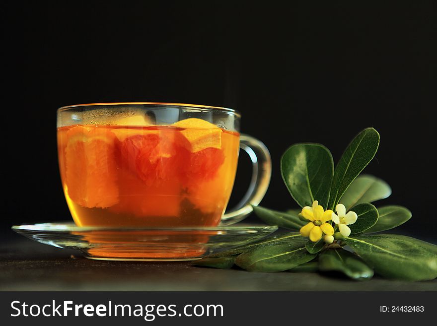 Hot tea with a flower on a black background