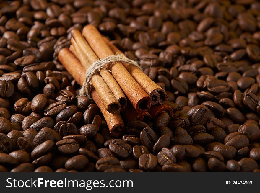 Cinnamon sticks connected to the coffee beans. Cinnamon sticks connected to the coffee beans
