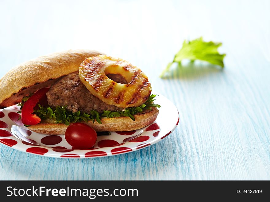 Fresh hamburger sandwich with lettuce, tomato and grilled pineapple