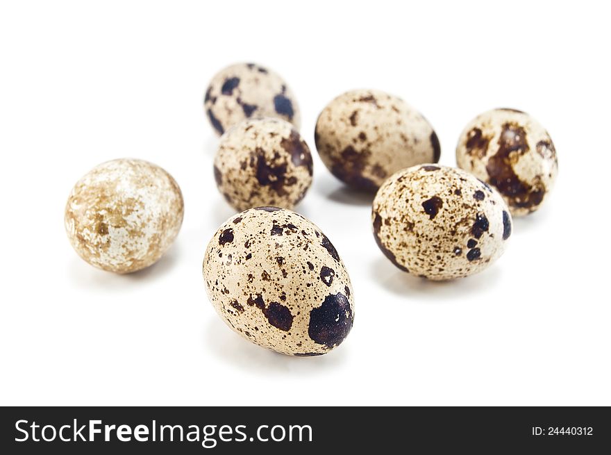 Some quail eggs on white