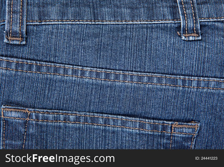 The texture of a blue denim, jeans. The texture of a blue denim, jeans