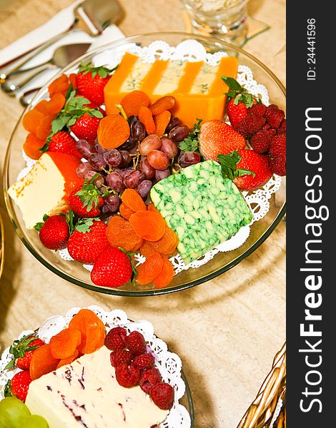 Delicious fruit and cheese platter featuring a variety of different cheeses and fresh fruits. Delicious fruit and cheese platter featuring a variety of different cheeses and fresh fruits.