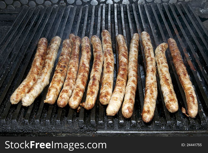 Sausages cooking on the grill in the restaurant. Sausages cooking on the grill in the restaurant