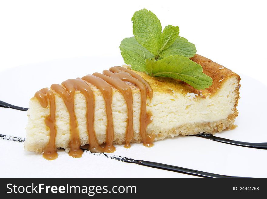 A piece of cheese cake with caramel sauce. A piece of cheese cake with caramel sauce