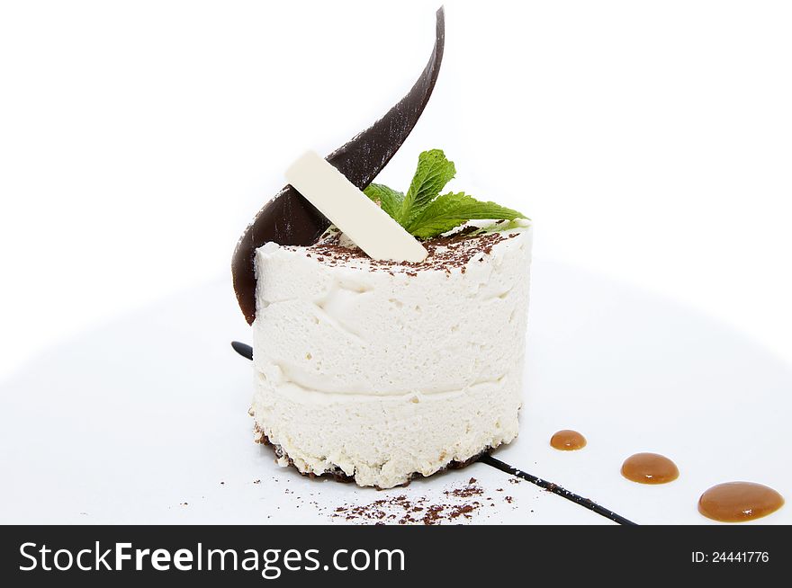 Cream dessert decorated with chocolate and mint